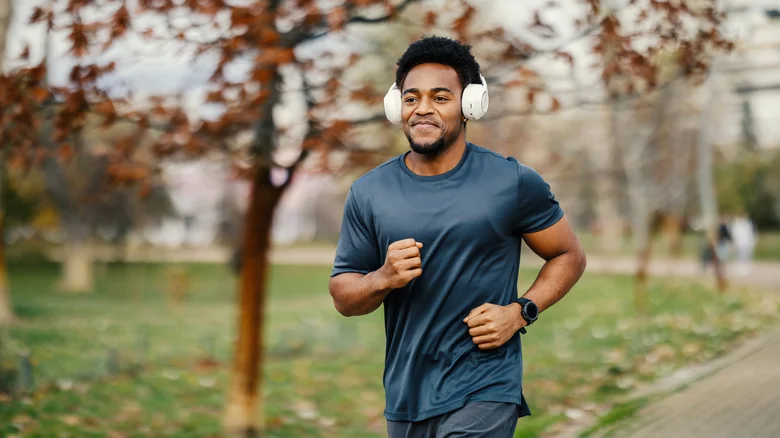 A man running with headphones on.