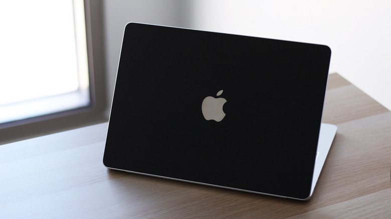 A MacBook on a desk.