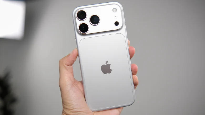The back of a silver iPhone 18 Pro held aloft.