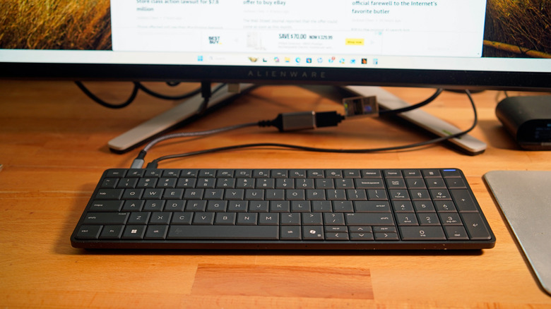 An HP EliteBoara G1a on a desk, connected to a monitor.