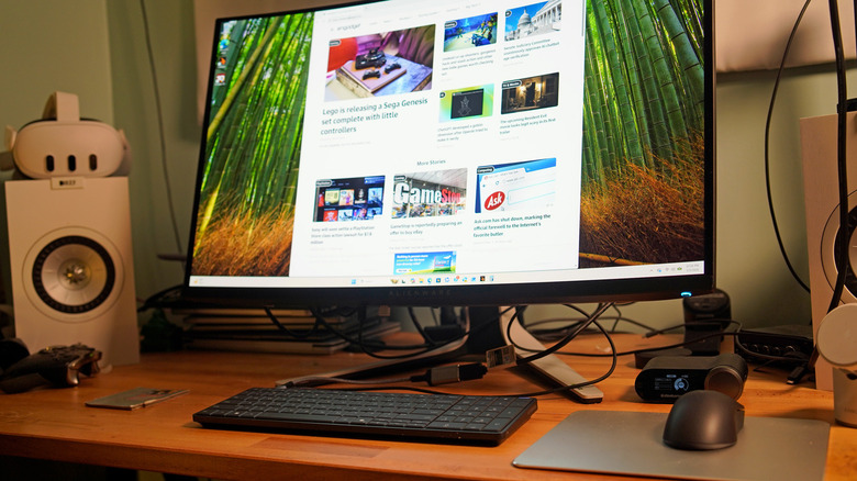 An HP EliteBoard G1a desktop on a desk powering an Alienware monitor.