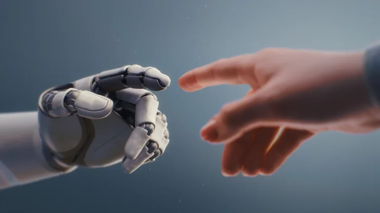 Robotic arm reaching out to a human hand.