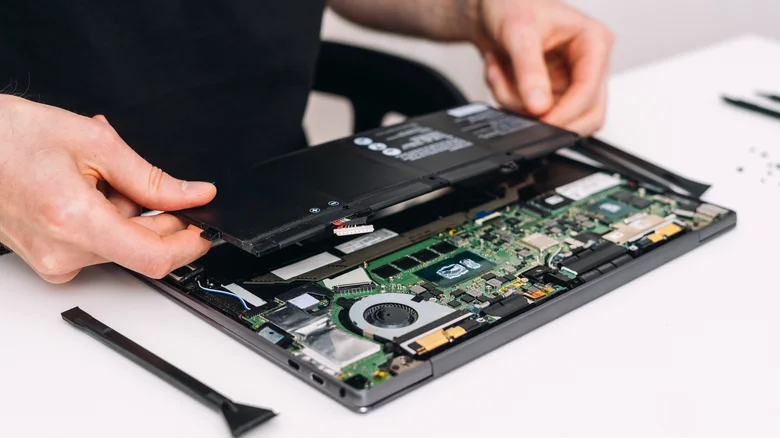 Tearing down a laptop and removing the battery.