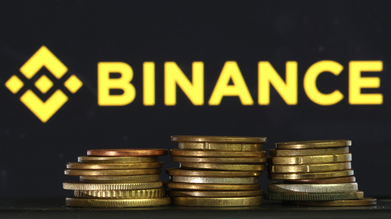 Binance logo shown behind stacks of coins