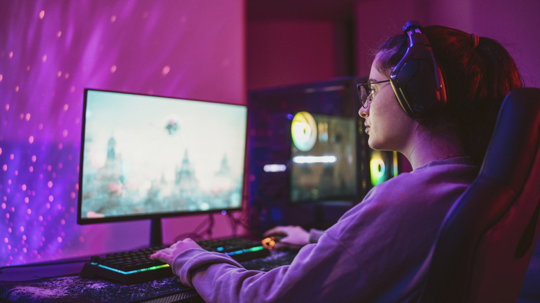 A woman playing video games on her desktop PC