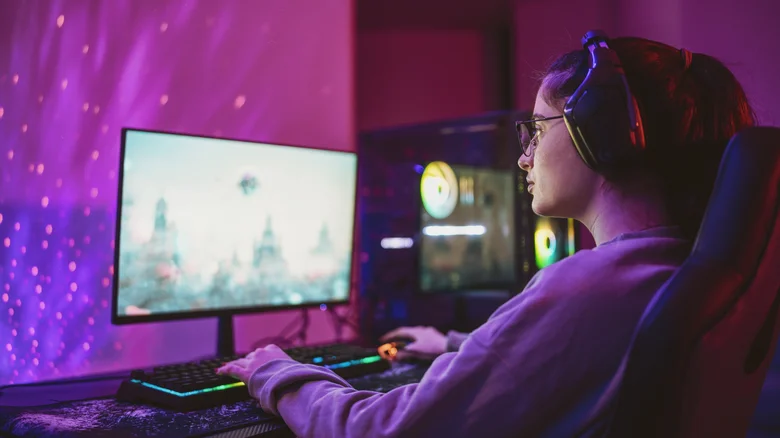 A woman playing video games on her desktop PC