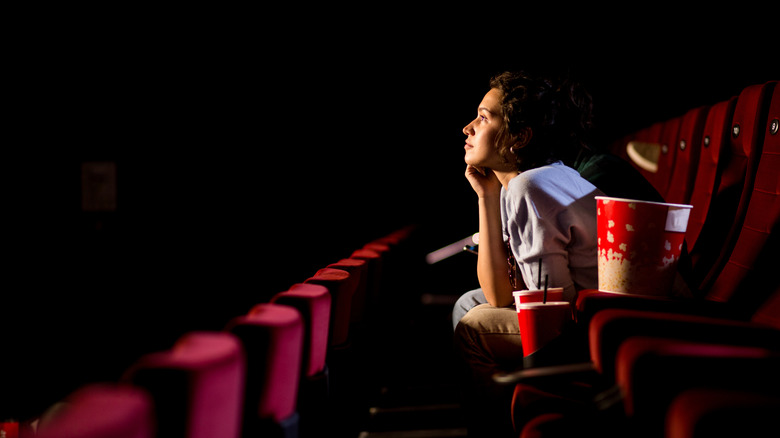 A woman watching a movie in a theater