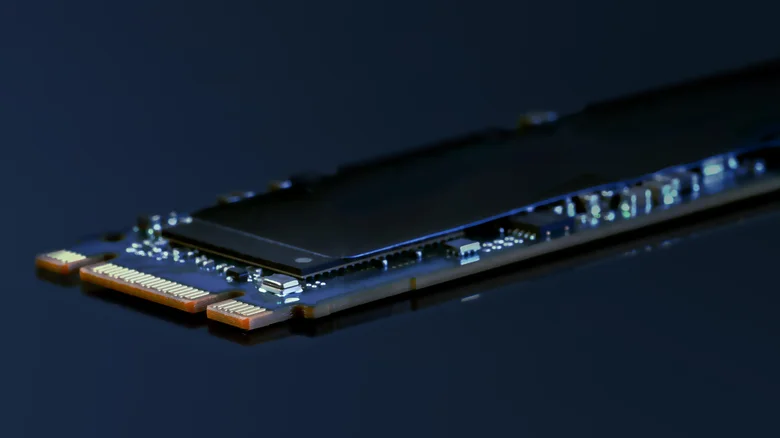 Close-up of an M.2 solid-state drive with exposed circuit board and memory chips.