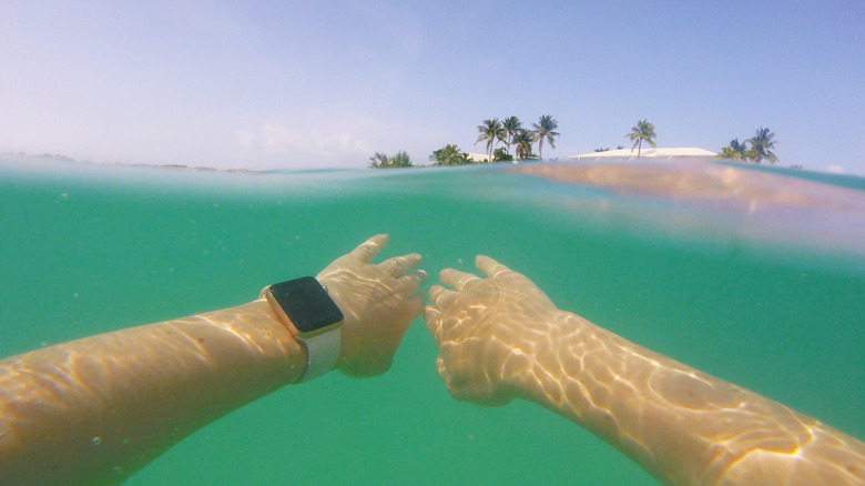 Someone swimming in the ocean with an Apple Watch on