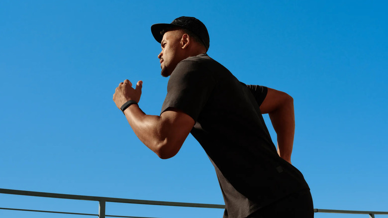 A man running while wearing his Fitbit Air.