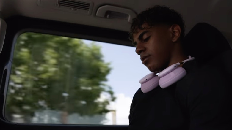 Soccer player Lamine Yamal is pictured in a car wearing pink headphones around his neck
