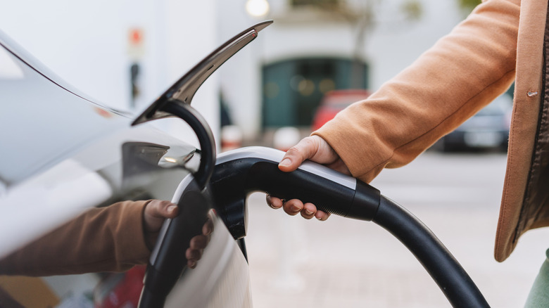 A charger plugged into an electric vehicle.
