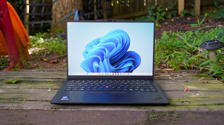 The ThinkPad X1 Carbon Gen 14 on a wooden stair.