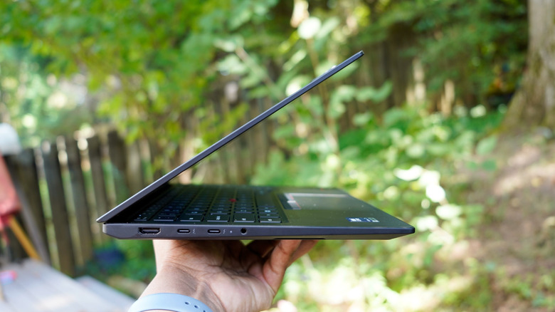 Holding up the ThinkPad X1 Carbon Gen 14.