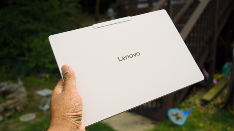 The Lenovo Yoga Slim 7i Ultra Aura Edition in a backyard.