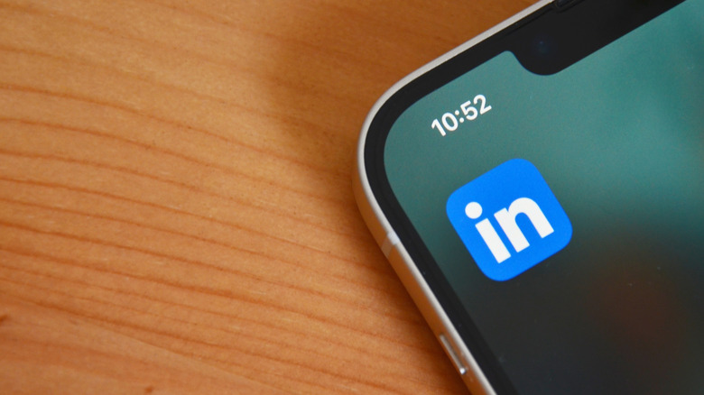 The LinkedIn logo on a phone on a desk.