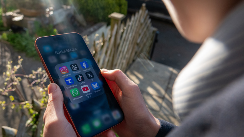 A boy using a smartphone to access social media apps.