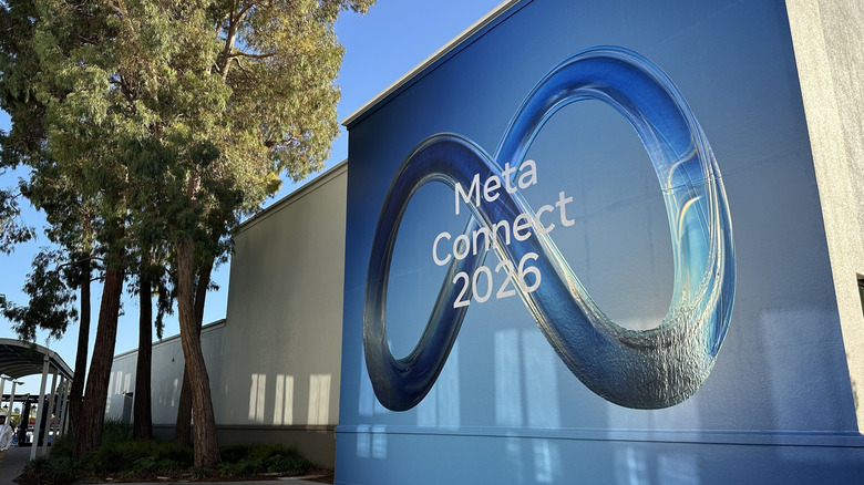 The Meta Connect 2026 logo on a wall next to some trees.
