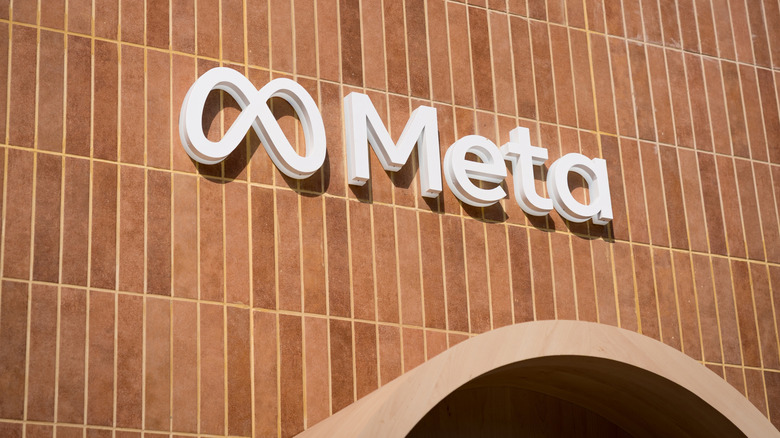 Meta's logo on the side of a brick-like building