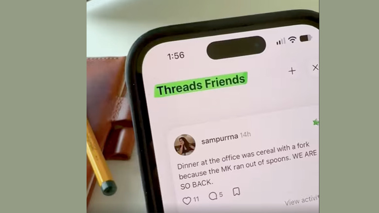 A phone with the Threads app open and the words 