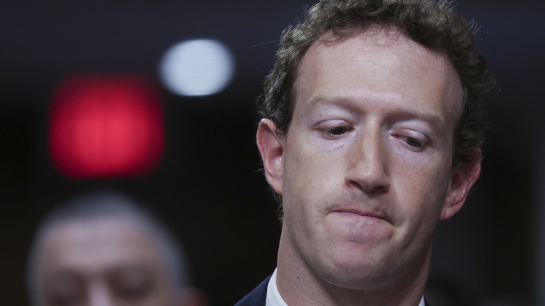 Mark Zuckerberg looking down.