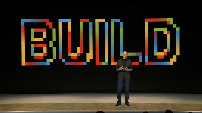 Microsoft CEO Satya Nadella standing onstage in front of a Build graphic.