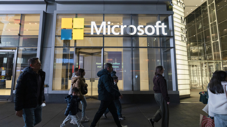 Crowd of people walking past Microsoft offices.