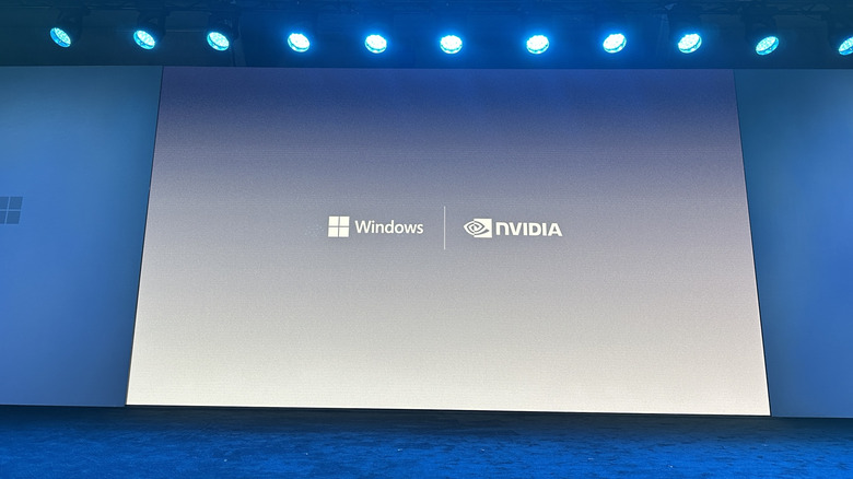 A screen on a stage showing the Windows and NVIDIA logos.