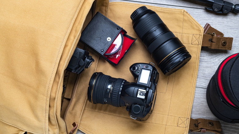 Professional DSLR camera with multiple lens attachments.