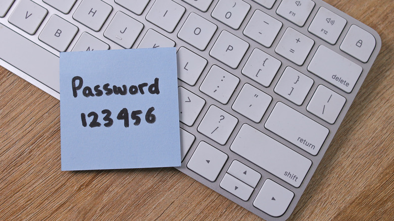 Sticky note with weak password on top of wireless keyboard.