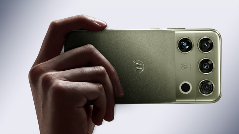 A hand holding a smartphone.