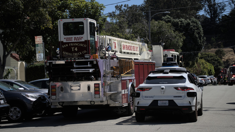 A Waymo vehicle getting in the way of a fire truck