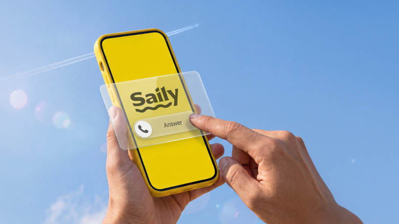 Hands holding a phone with the Saily logo