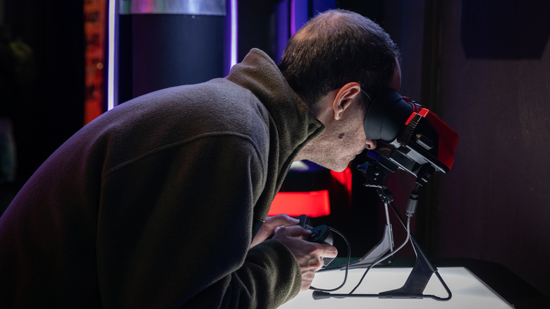 A man playing a Virtual Boy system.