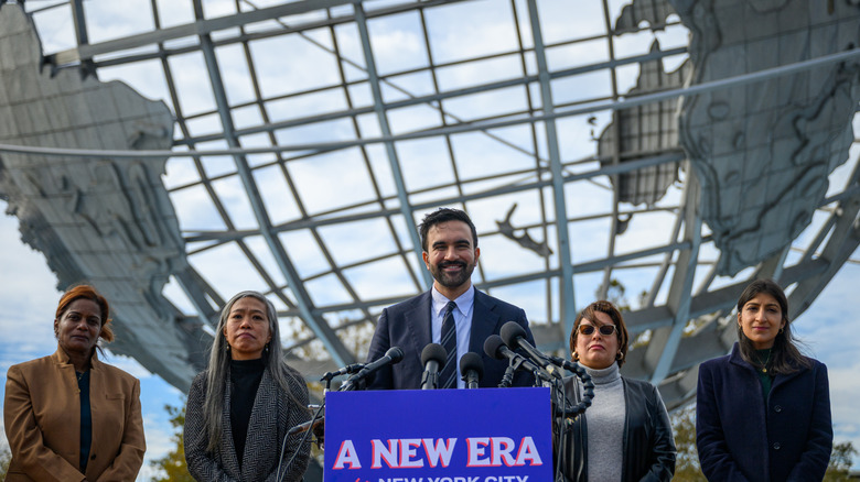 Mayor Mamdani, Lina Khan and others near a podium.