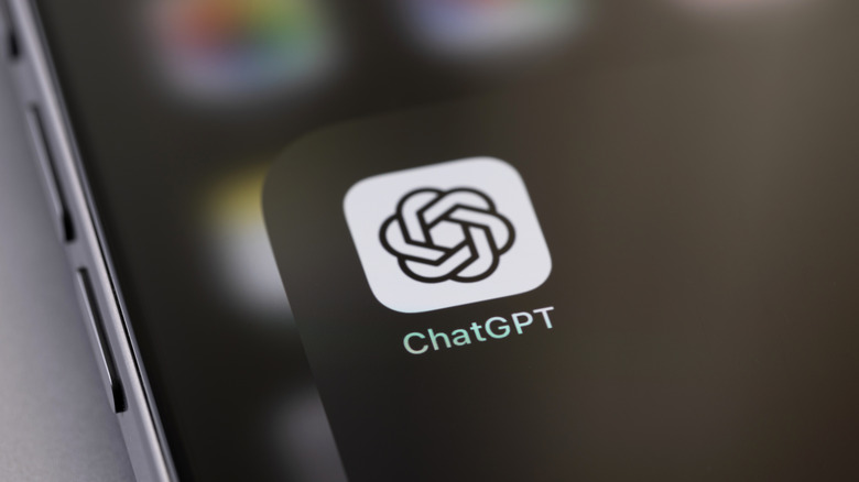 Close-up photo of a smartphone displaying the ChatGPT app logo in a folder