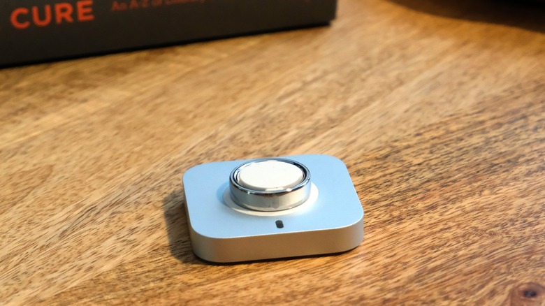 Oura Ring 5 on its charging plate.