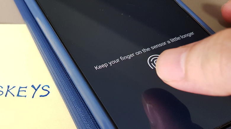 Finger being scanned on phone with a 