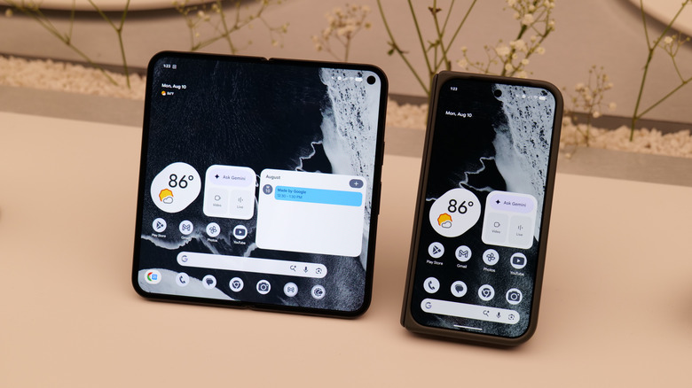 A Pixel 11 Pro Fold open sitting next to another that's closed.