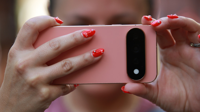 Close up of the back of the Pixel 11 Pro as a person holds it horizontally to take a photo.