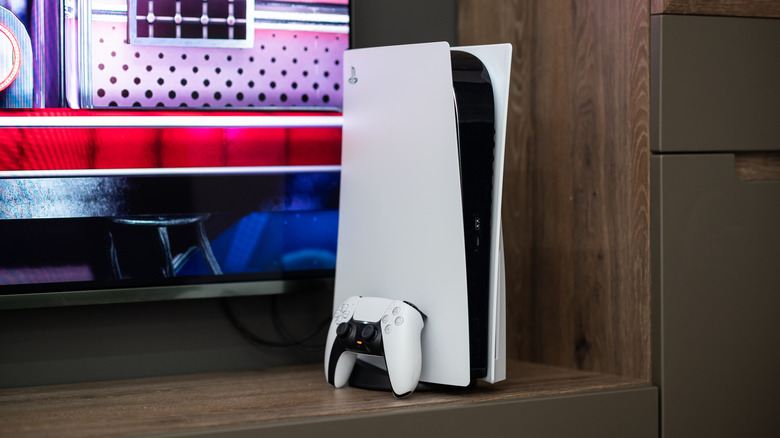 A PS5 console in front of a TV.