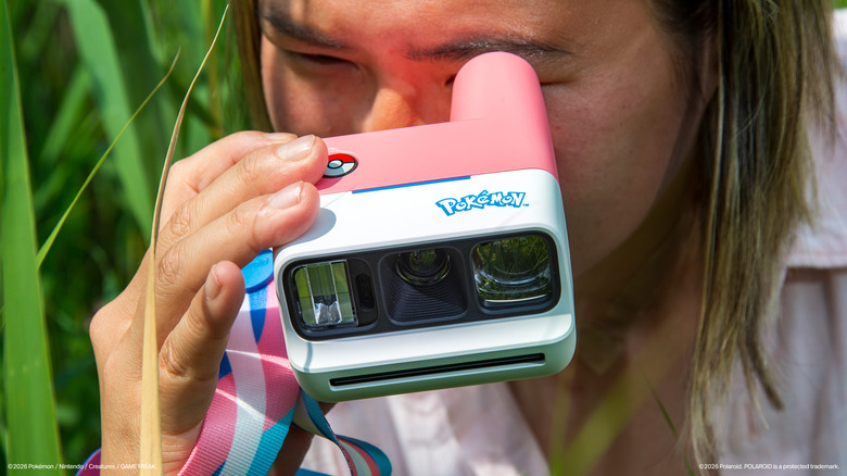 Someone shooting a photo with a Sylveon-themed Polaroid camera.