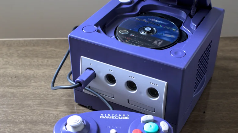 A Nintendo GameCube with its disc tray open.