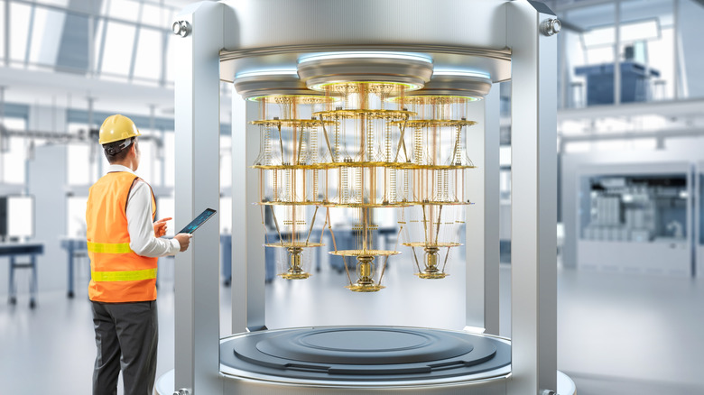 An engineer standing next to a quantum computer.