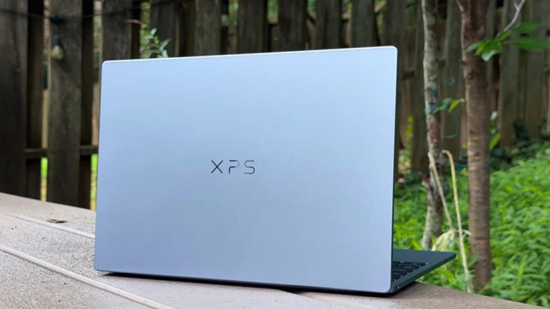 The 2026 Dell XPS 13 with the lid open, viewed from the rear.