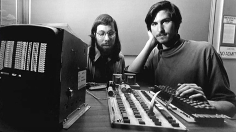 Photo of Steve Wozniak and Steve Jobs posing with an Apple I computer in the company's early days