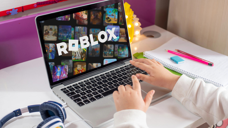 A child using a computer with Roblox on it.