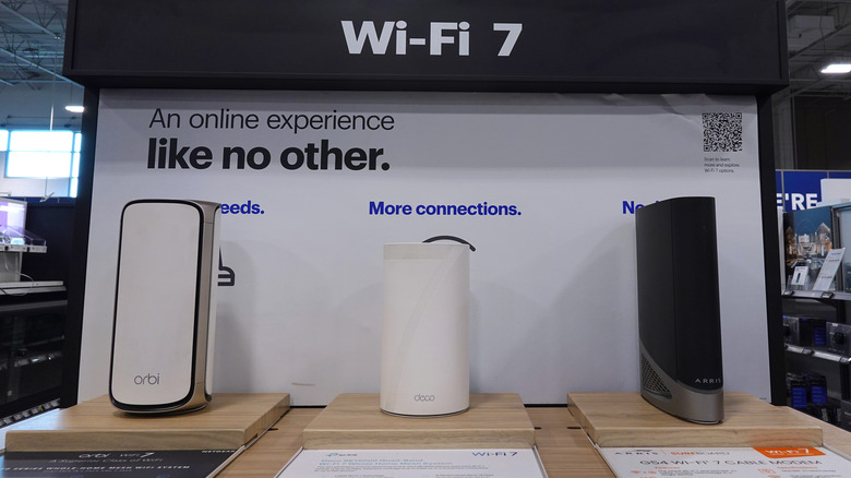 Three Orbi Wi-Fi 7 routers at a trade show