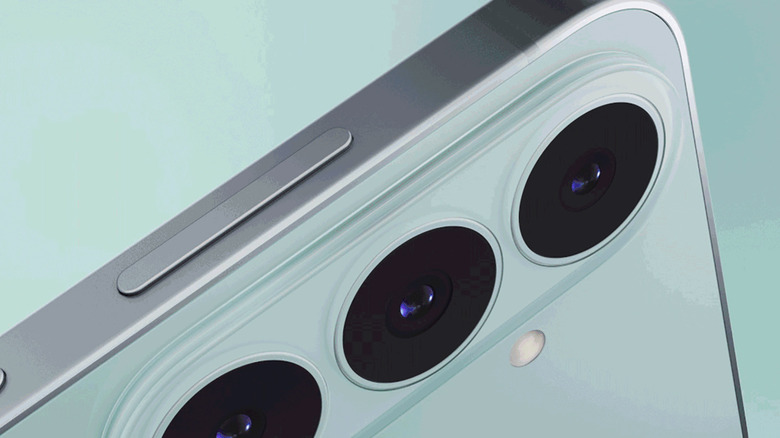 The corner of the Samsung Galaxy S26 FE showing the camera lenses on a pastel green background.