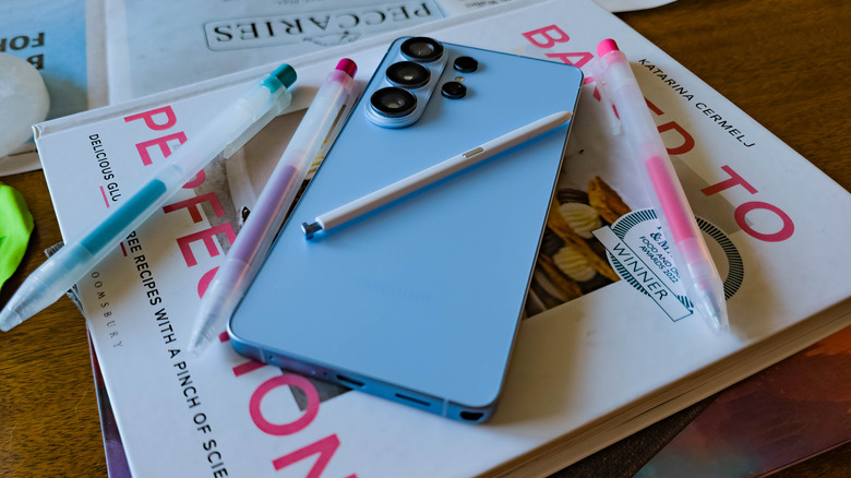 Samsung Galaxy S26 Ultra posed on table with books and pens